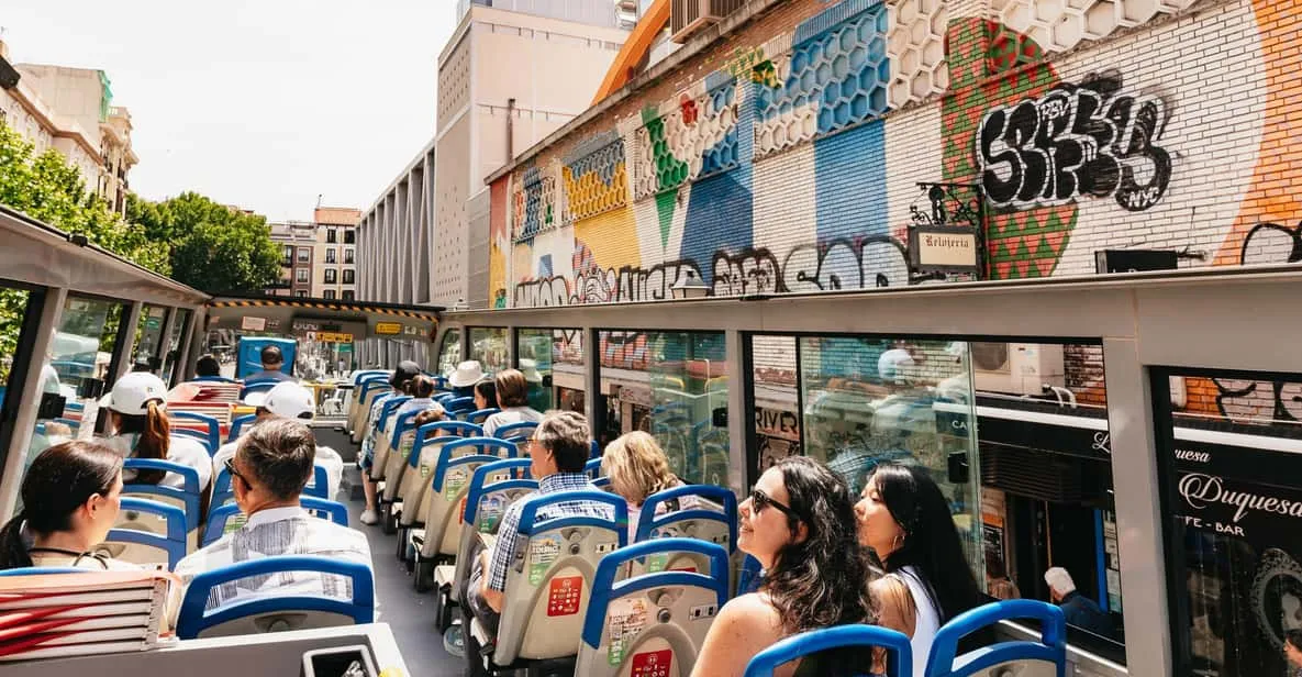 An open-top sightseeing bus passing the museums of Madrid, Spain